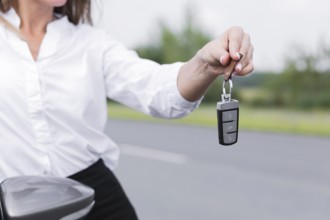 Close up woman holding car keys
