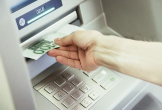 Young woman withdrawing money from a cash machine
