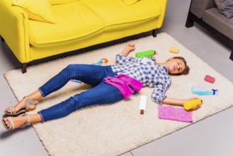 Exhausted young woman after cleaning house