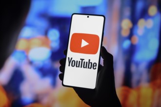 In this photo illustration, the YouTube logo is displayed on a smartphone screen