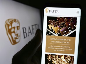 Stuttgart, Germany, 07-14-2023: Person holding cellphone with webpage of British Academy Film