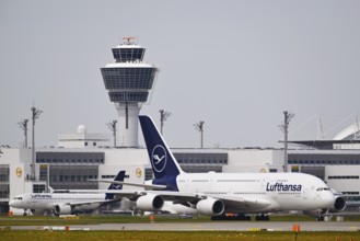 Lufthansa Airbus A380-800 with control tower, taxiing in front of Terminal 2 to runway South