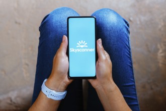 In this photo illustration, the Skyscanner logo is displayed on a smartphone screen