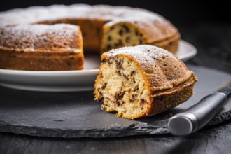 Homemade vegan banana cake baked in bundt pan decorated with powdered sugar