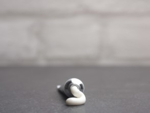 Close up of a cream tube on a bathroom table