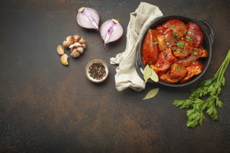 Cooking hearty meat stew. Raw uncooked chopped pieces of meat marinated with seasonings and parsley