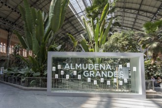 At Almudena Madrid's Puerta de Atocha?Almudena Grandes station, commuters await trains amidst