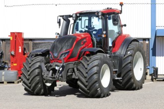 Red Valtra T235 tractor parked outside at the AGCO agricultural machinery dealership. Salo, Finland