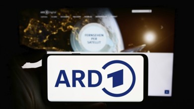 Stuttgart, Germany, 04-10-2024: Person holding cellphone with logo of German public-service