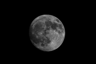 The full moon in black and white against a dark night sky makes for an impressive, clear image,