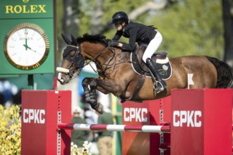 Katie Laurie of Australia riding on Django II competes in the second round and jumpoff of the CPKC