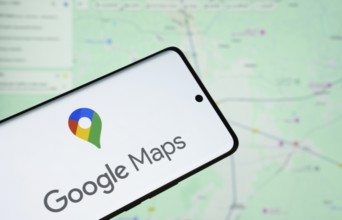 The logo of the google maps is displayed on a smartphone screen, and the website google maps is