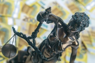 Justitia Figure with 200 euro bills in the Background. Concept justice and money
