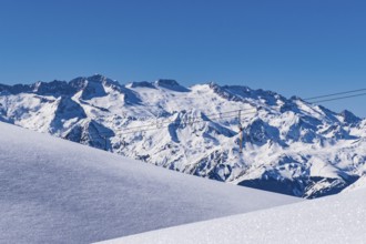 Snow-covered mountains under a clear blue sky, creating a serene winter landscape, Aneto Peak,