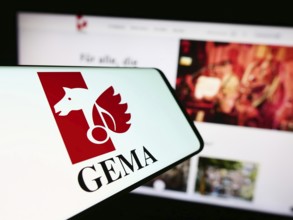 Stuttgart, Germany, 12-14-2023: Cellphone with logo of German collecting society GEMA in front of
