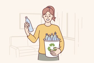 Woman puts plastic bottles in recycling bin showing awareness and concern for environment. Young
