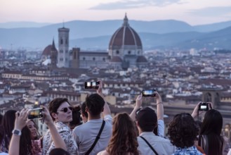 FLORENCE, ITALY, SEPTEMBER 21, 2023, Large tourist crowd on Piazzale Michelangelo enjoying sunset