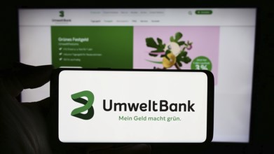 Stuttgart, Germany, 02-12-2024: Person holding cellphone with logo of German financial services
