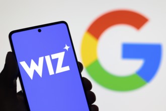In this photo illustration, the Wiz logo seen displayed on a smartphone screen and the Google logo