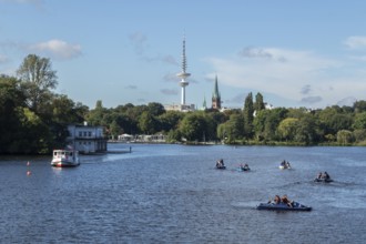 Leisure activities in summer, pedal boats and Alster-Touristik barge Susebek in front of a blue sky