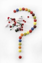 Candy sweets question mark isolated over white background and pills