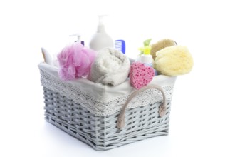 Bath toiletries basket with shower gel shampoo sponge and towel