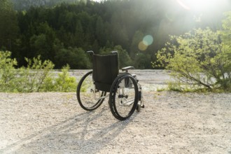 Photo of empty wheelchair parked in park, health care concept