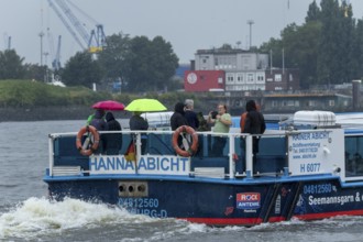 Symbolic picture weather, heavy rain in summer, thunderstorm, storm, tourists with umbrellas in the