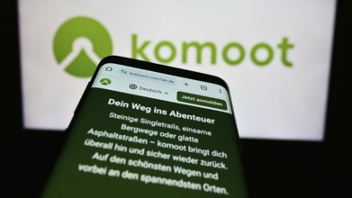 Stuttgart, Germany, 05-23-2024: Cellphone with web page of German route planning app company komoot