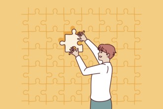 Business man putting last piece of puzzle in free space for problem solving concept. Guy in