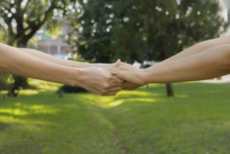 Two woman holding their hands