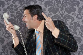 Businessman shouting angry expression and rude finger talking by telephone with retro mustache