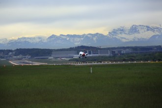Landing of a Fokker 100 at Zurich Airport. View of the Swiss Alps