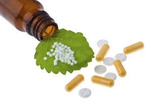 Homeopathy. Globules as an alternative medicine. Lying on a sheet, Homeopathy. Globules as