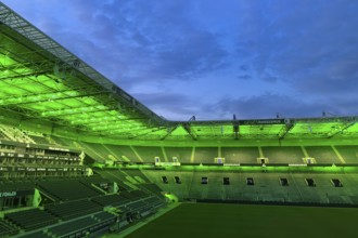 Football stadium Borussiapark without spectators, illuminated in green, sunset, Mönchengladbach,
