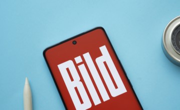 The logo of the German newspaper Bild is displayed on a smartphone screen