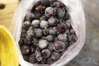 Bag of frozen blueberries covered in frost, giving a textured appearance