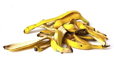 A pile of banana peels, organic fruit waste on a white background