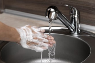 Side view woman washing hands sink