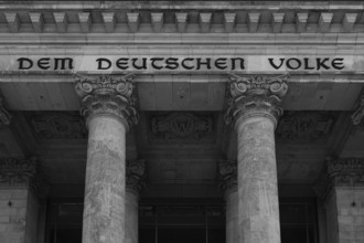 Reichstag building with the inscription Dem Deutschen Volke, black and white, Berlin, Germany,