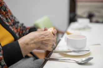 Close up of elderly woman enjoying breakfast.