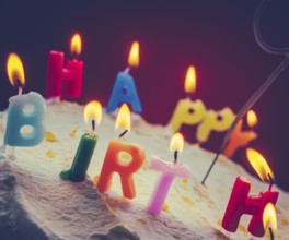 Retro Filtered Photo Of Children's Birthday Candles On A Cream Cake