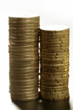 Euro coin columns, golden cash over white background at studio