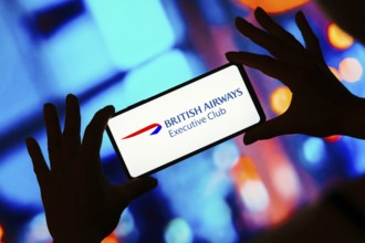 In this photo illustration, the British Airways Executive Club logo seen displayed on a smartphone