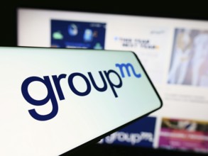 Stuttgart, Germany, 11-03-2023: Cellphone with logo of American media investment company GroupM in