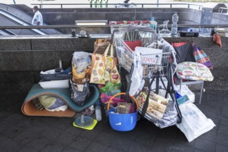 Hanover - Poverty, homelessness. Belongings in plastic bags and a shopping trolley on the stairs to