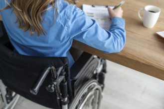 Close up woman wheelchair working office