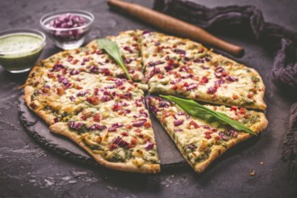 Tart flambee (Flammkuchen) with ramson sour cream (bear leek), onion and bacon