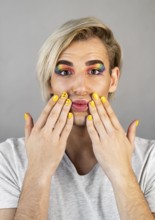 Man wearing make up cosmetics nail polish