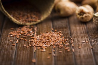 Seeds and onions on wooden table